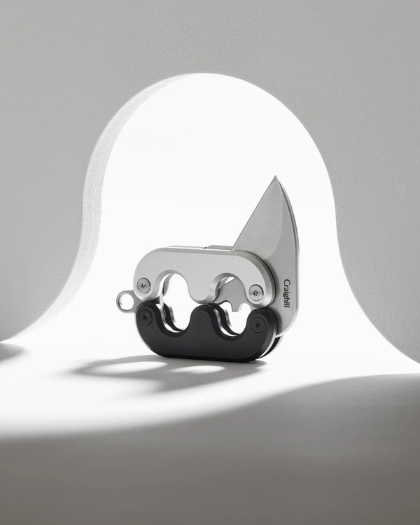A knife with a unique handle on a gray background