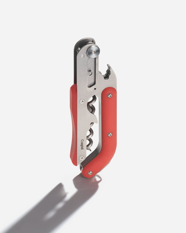 Red and silver corkscrew on a white background