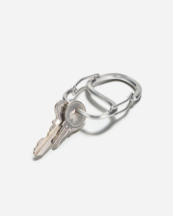 Silver keychain with a key on a white background