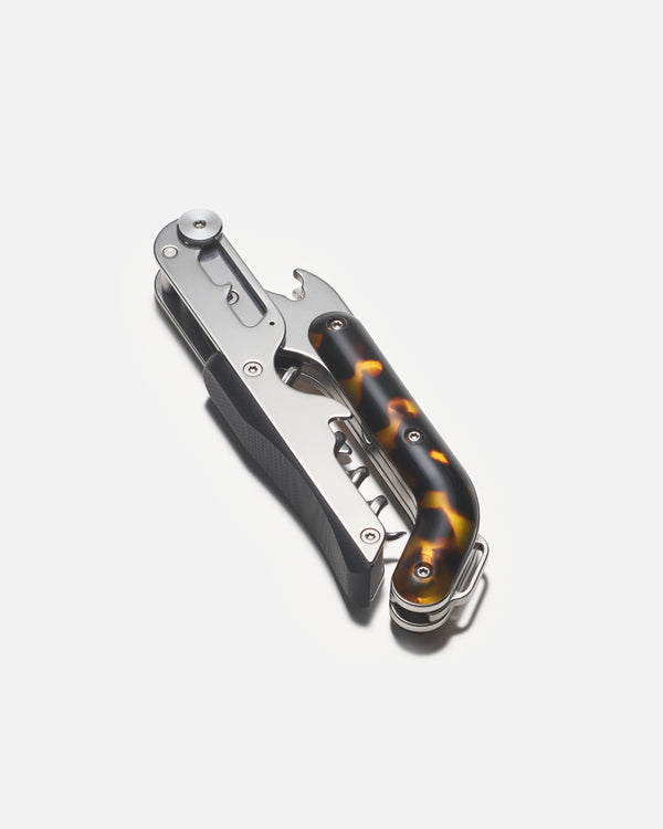 Wine opener with bottle opener and knife on a white background