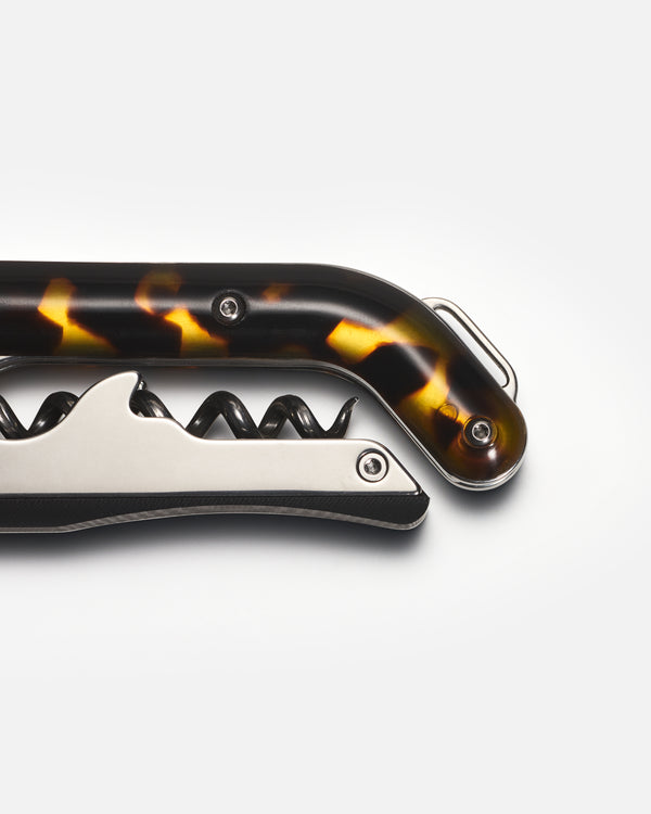 Corkscrew with tortoiseshell handle on a white background