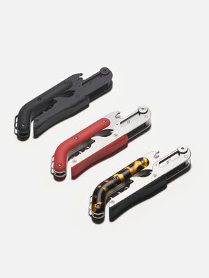 Three bottle openers in black, red, and tortoiseshell design on a white background