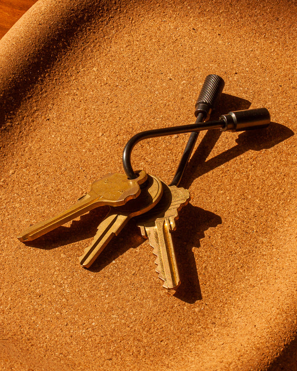 Set of keys with a lock on a textured brown surface