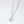 Silver necklace with a moon and red stone pendant on a white background