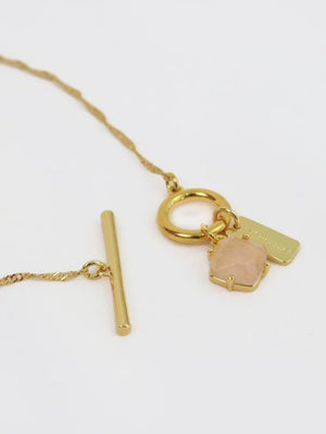 Gold necklace with a pendant on a white background