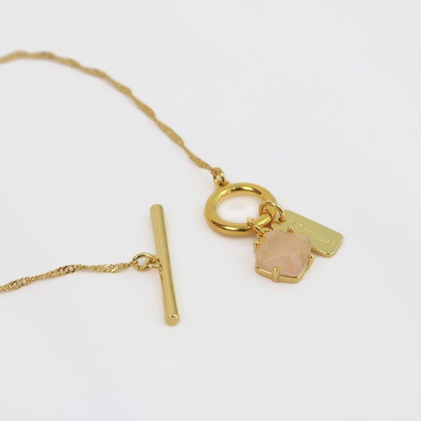 Gold necklace with a pendant on a white background