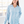 Woman wearing a light blue shirt in an indoor setting