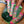 Sheer socks with tennis racket design worn by a person sitting on a woven chair.