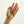 Hand holding a set of keys with a keychain against a light background