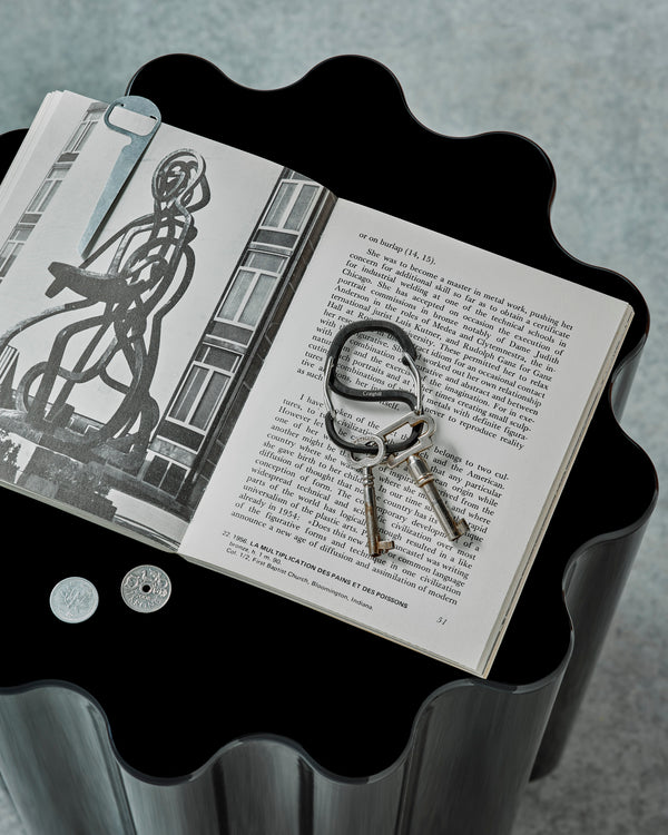 Open book with keys on a black surface