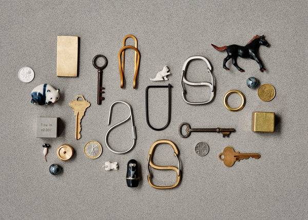 Collection of various keys and metal objects on a gray background